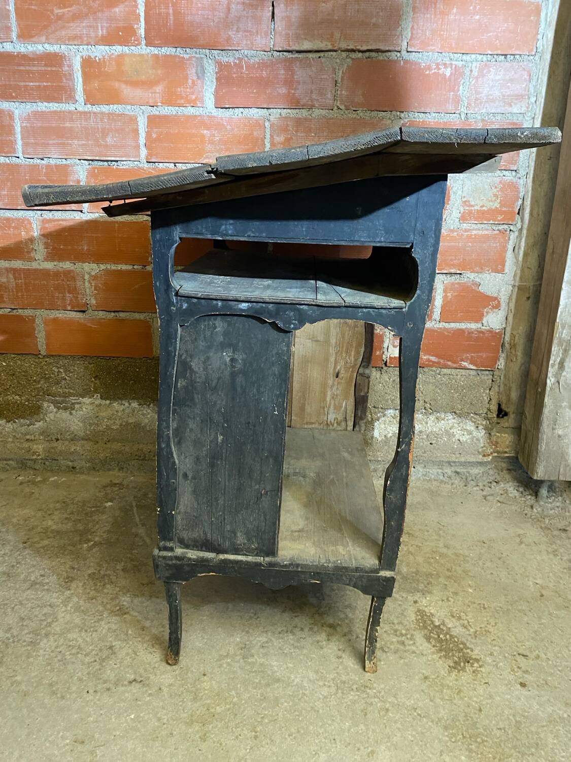 Antique writing desk, blackened wooden filing cabinet.