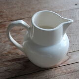 Old pitcher in white earthenware