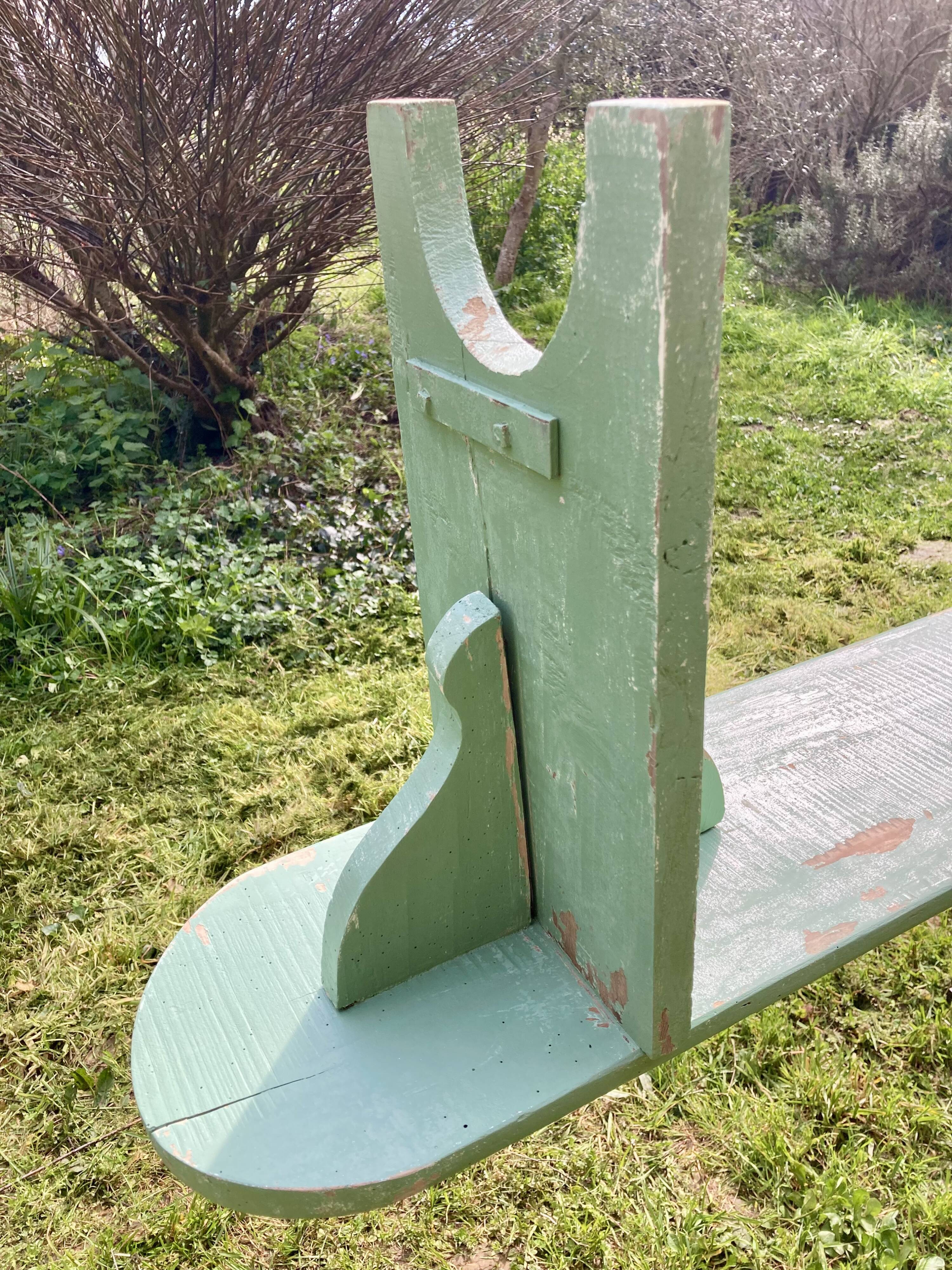 Old curved wooden farm bench