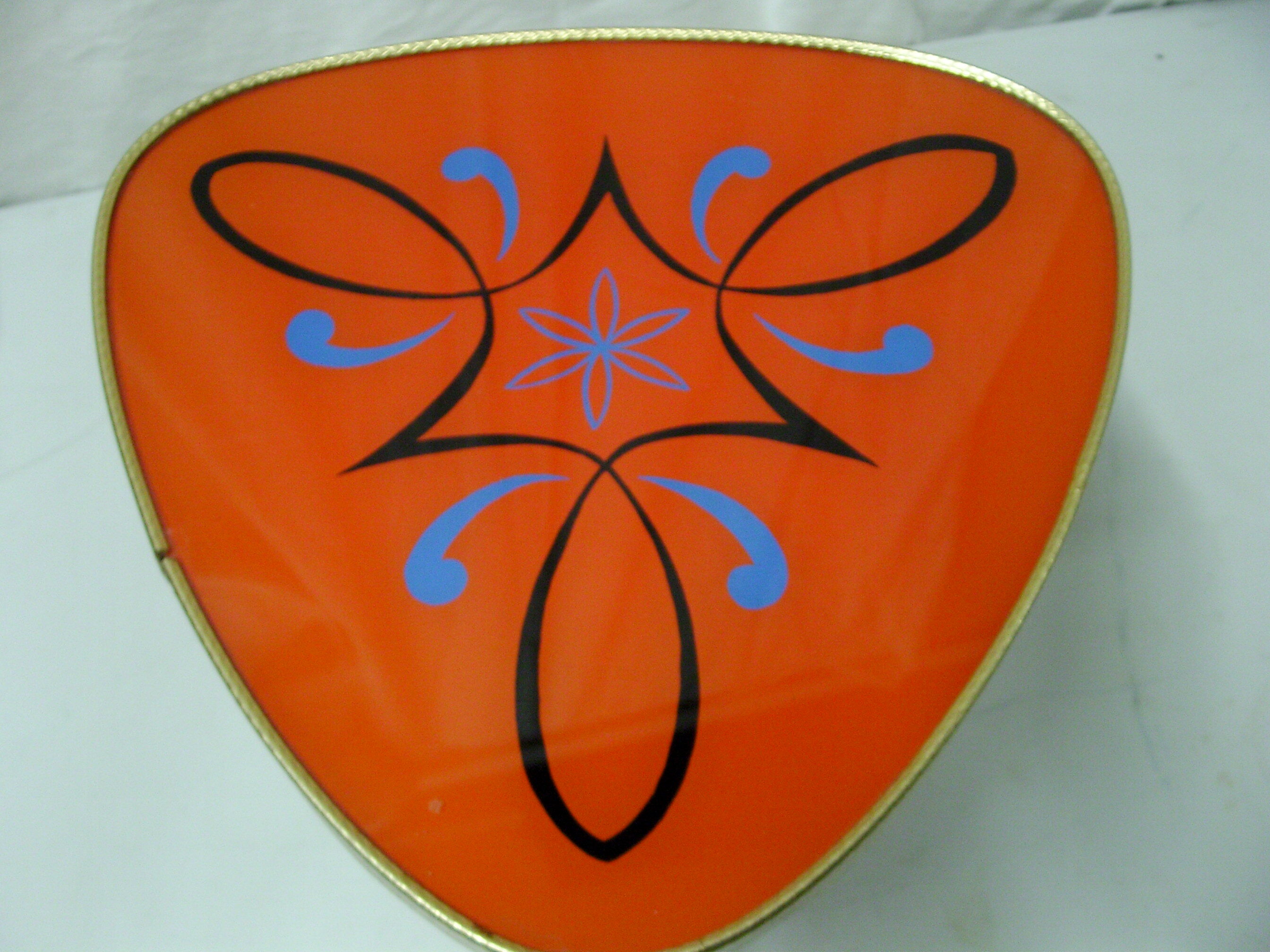 Plant holder tripod in geometrically patterned orange formica