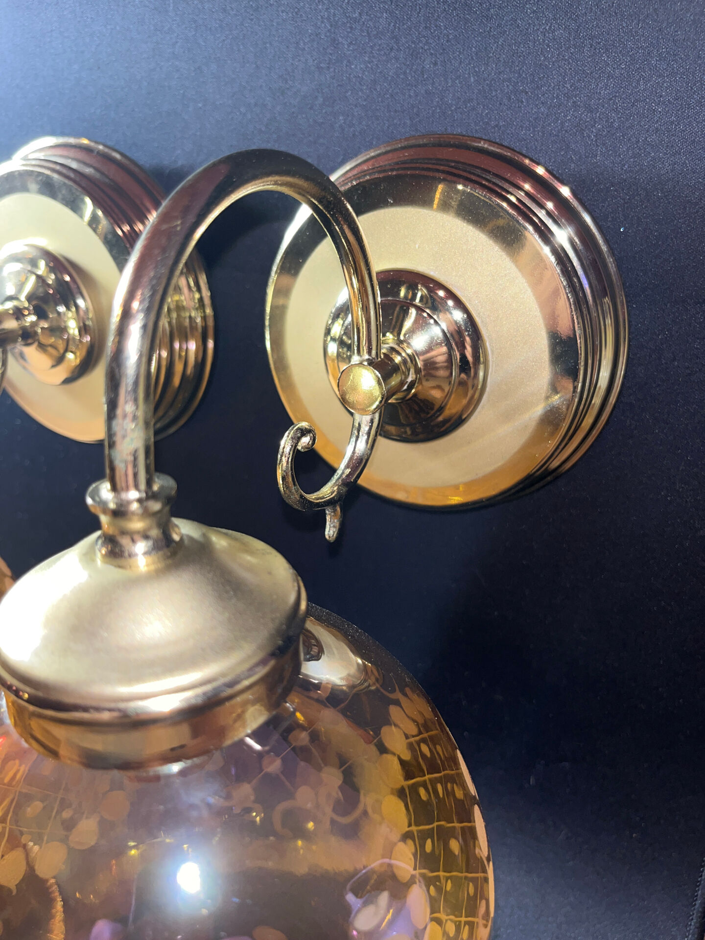 Pair of vintage wall sconces in brass with amber glass globes.