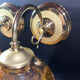 Pair of vintage wall sconces in brass with amber glass globes.