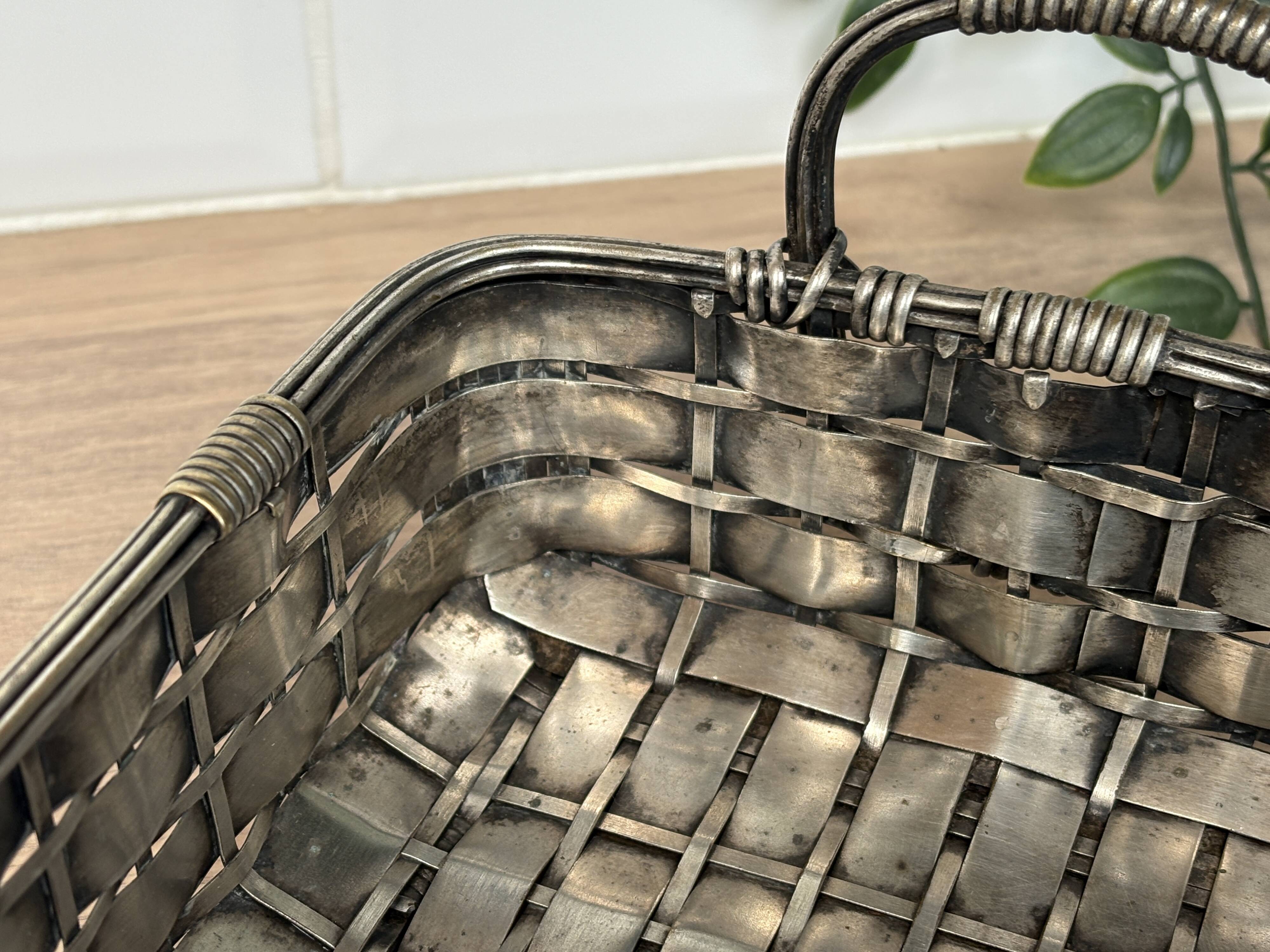 Woven silver-plated metal basket.