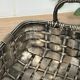 Woven silver-plated metal basket.