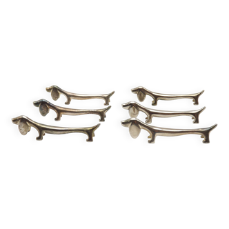 A delightful set of 6 French vintage cutlery rests in the shape of a elongated Dachshund Dog.   Here