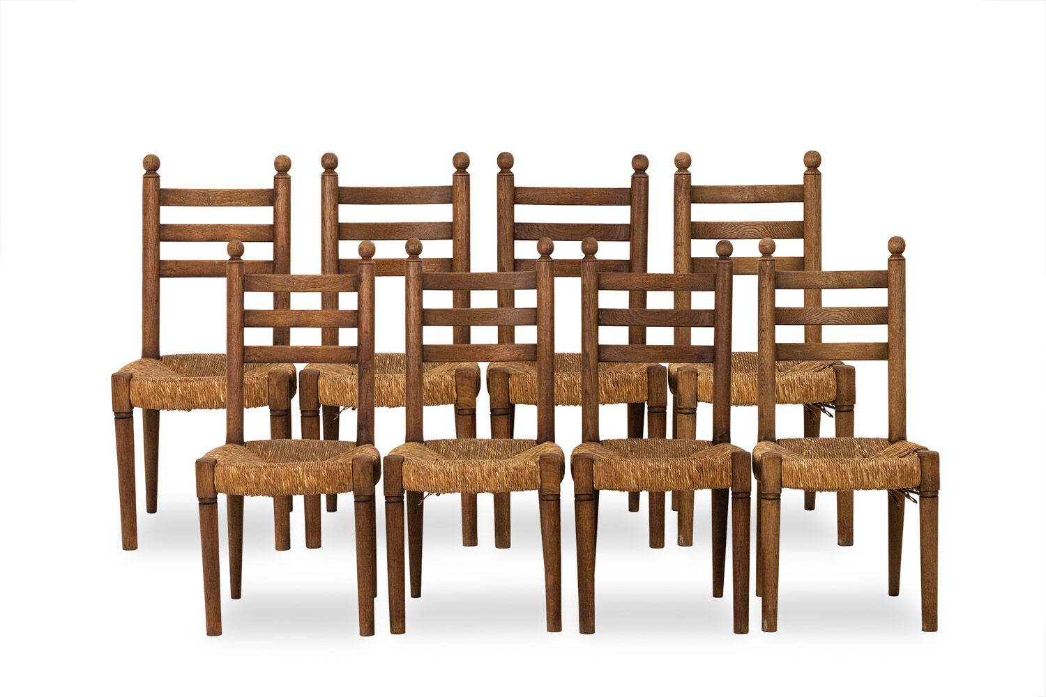 Ensemble de 8 chaises paillées en chêne. Années 1950.