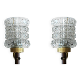 Pair of wall sconces in textured glass, wood, and gold metal, 1970.