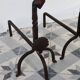 Vintage metal and cast iron fire dogs with shell motif.