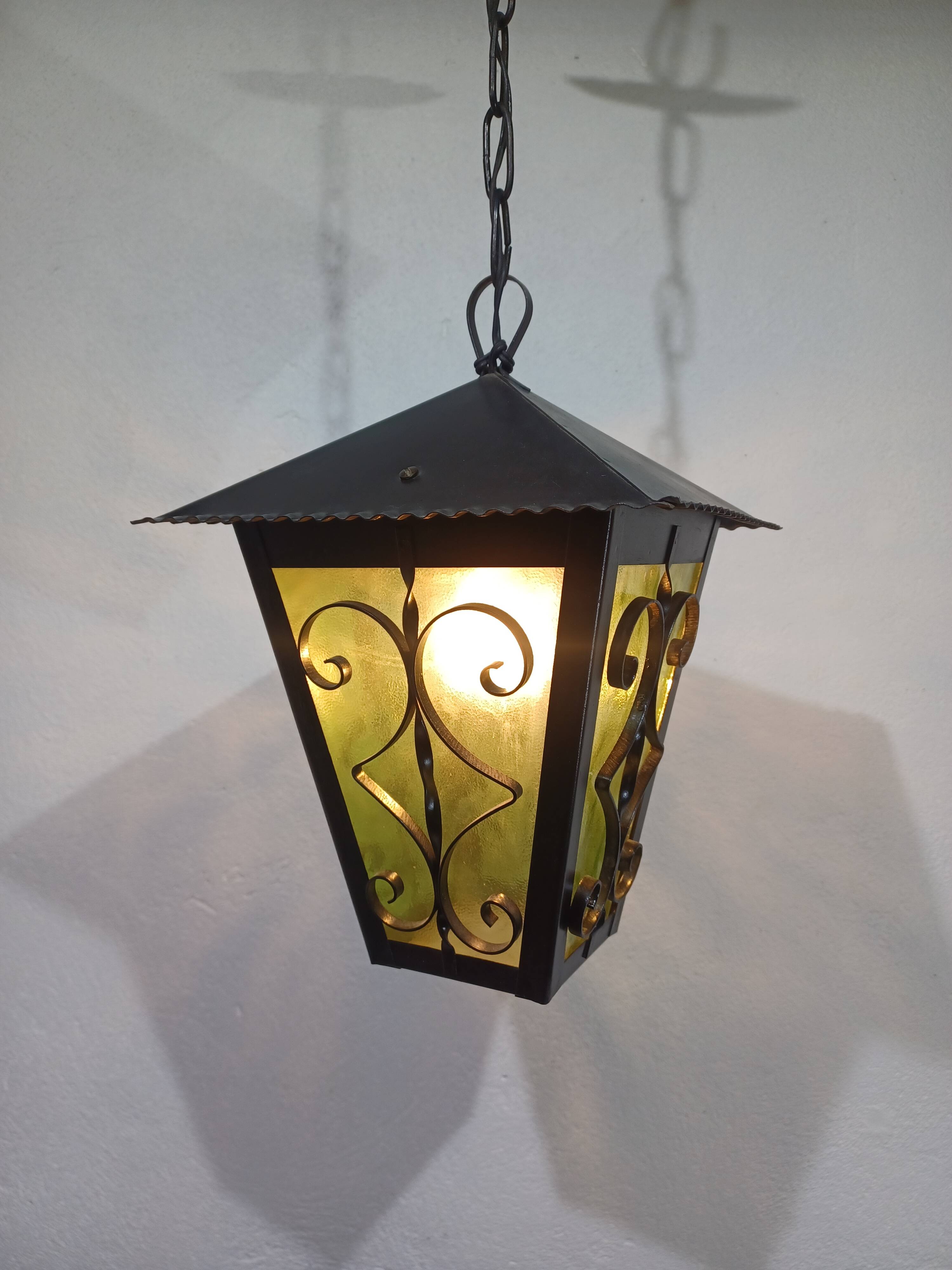 Wrought iron and green glass lantern