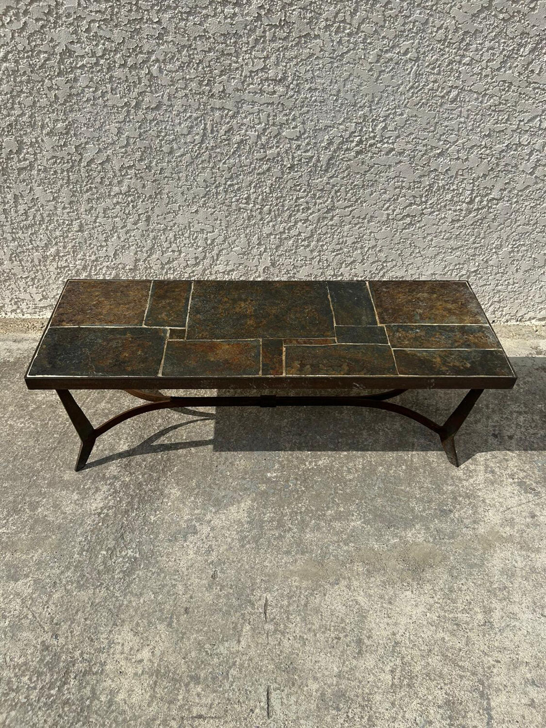 Coffee table with stone top and iron legs