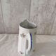 Earthenware milk jug with small flower patterns.