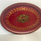Old oval plate in painted red tin - floral decoration - early 20th century -