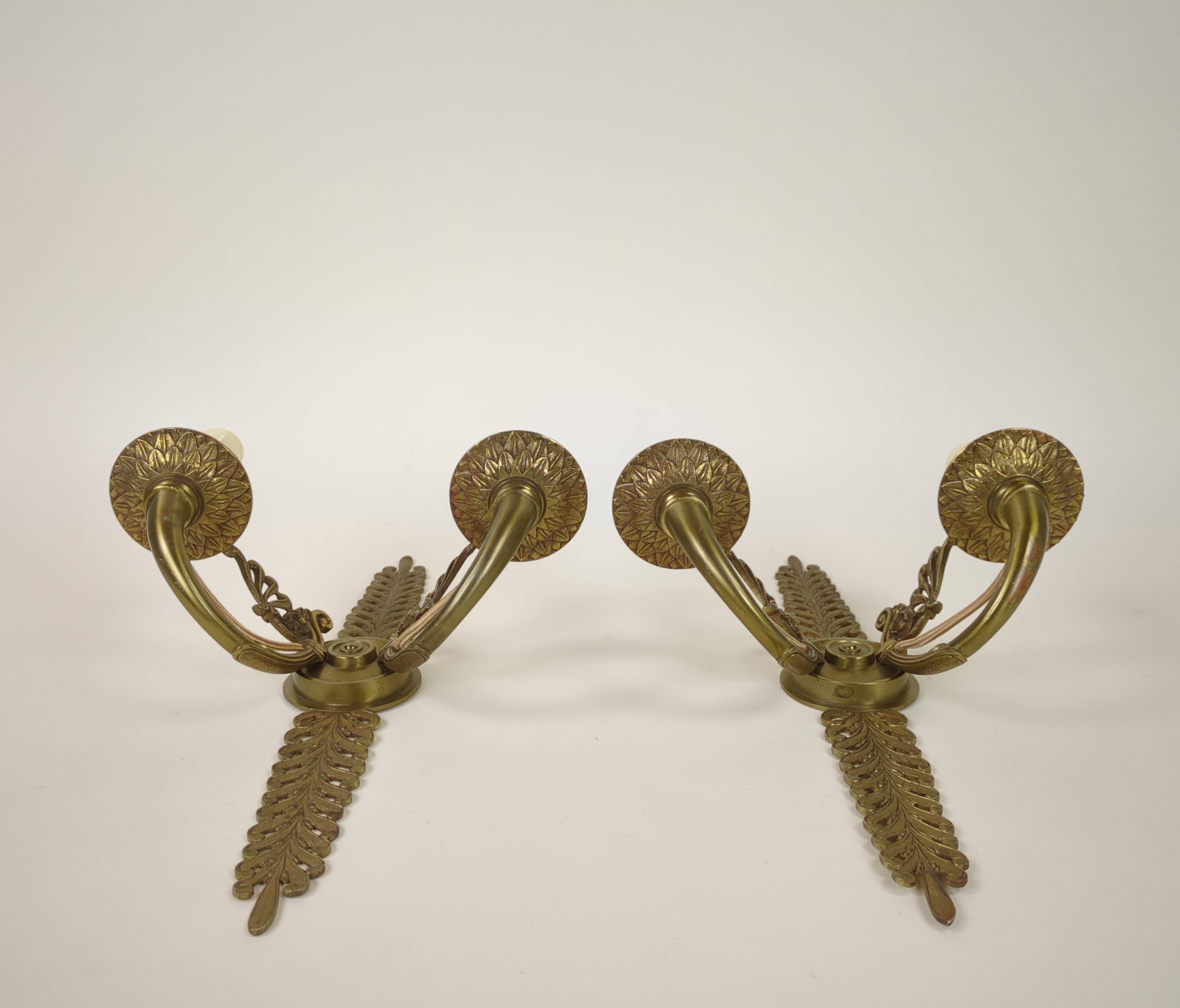 Pair of two-armed Empire wall sconces in gilded bronze