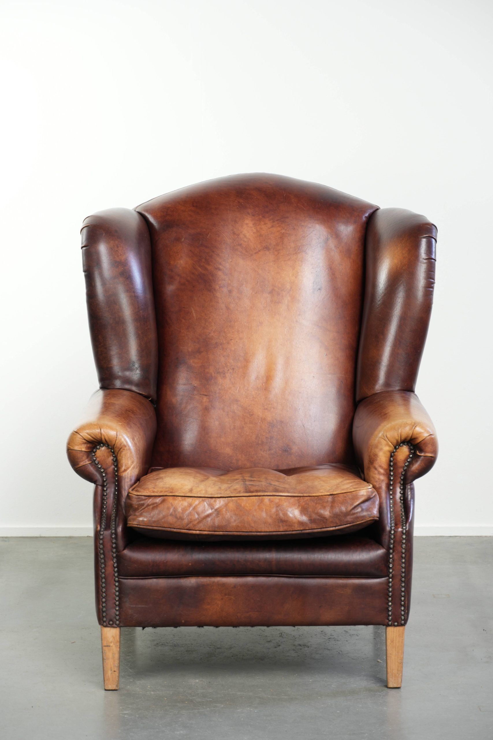 Comfortable cowhide wingback armchair in English style