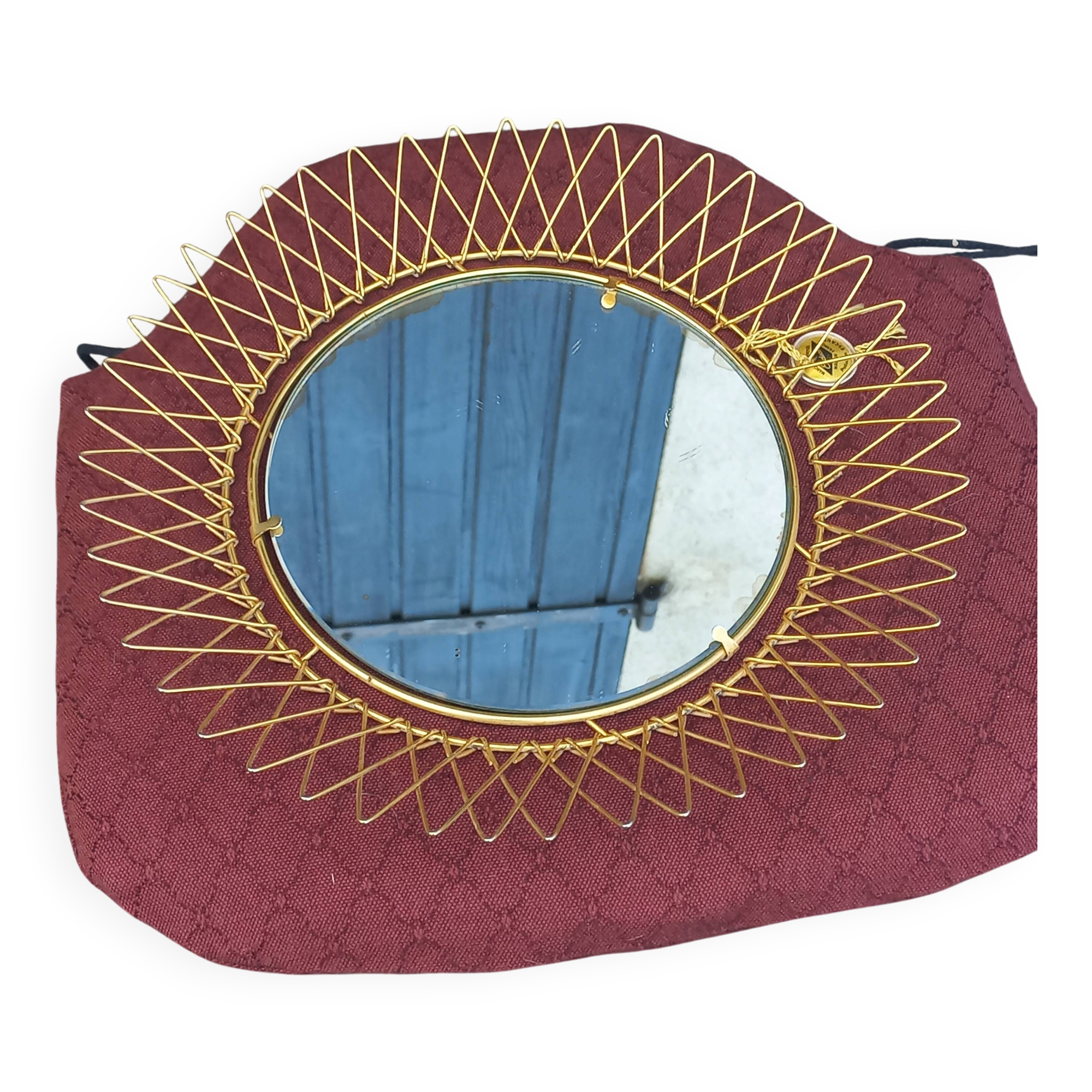 Vintage 1950s sun mirror in gold metal.