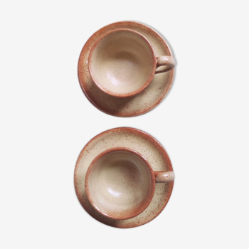 Pair of sandstone coffee cups with saucers