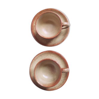 Pair of sandstone coffee cups with saucers