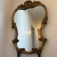 Large wall mirror with a gilded brass frame in Louis XV style.