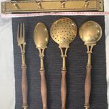 Old kitchen utensils in brass and wood.