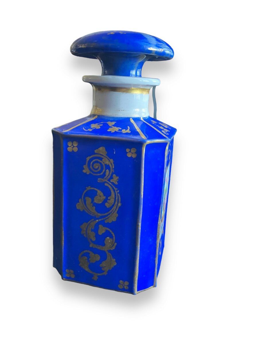 Perfume bottle in porcelain of old paris blue background