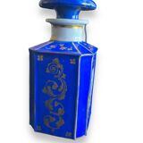 Perfume bottle in porcelain of old paris blue background