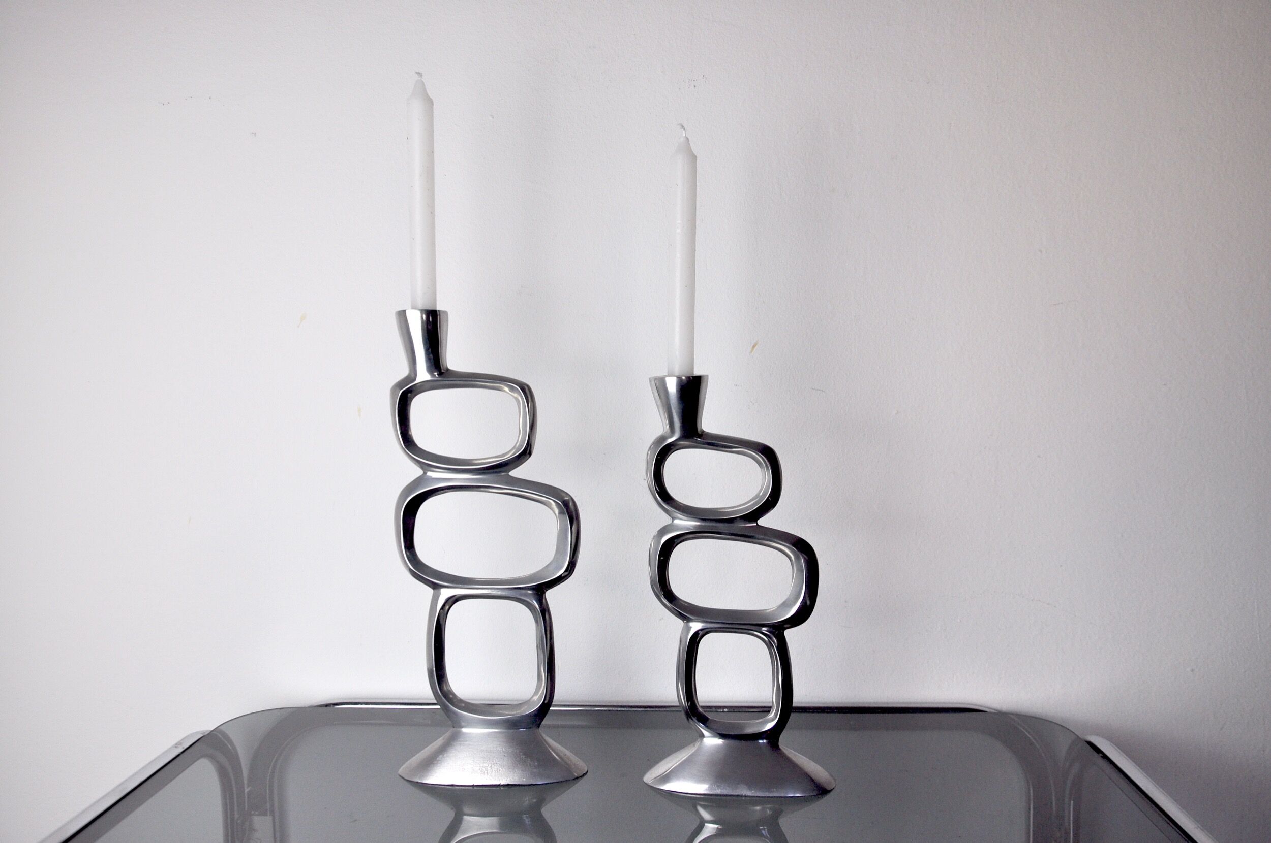 Pair of circle candlesticks by matthew hilton, england, 1980
