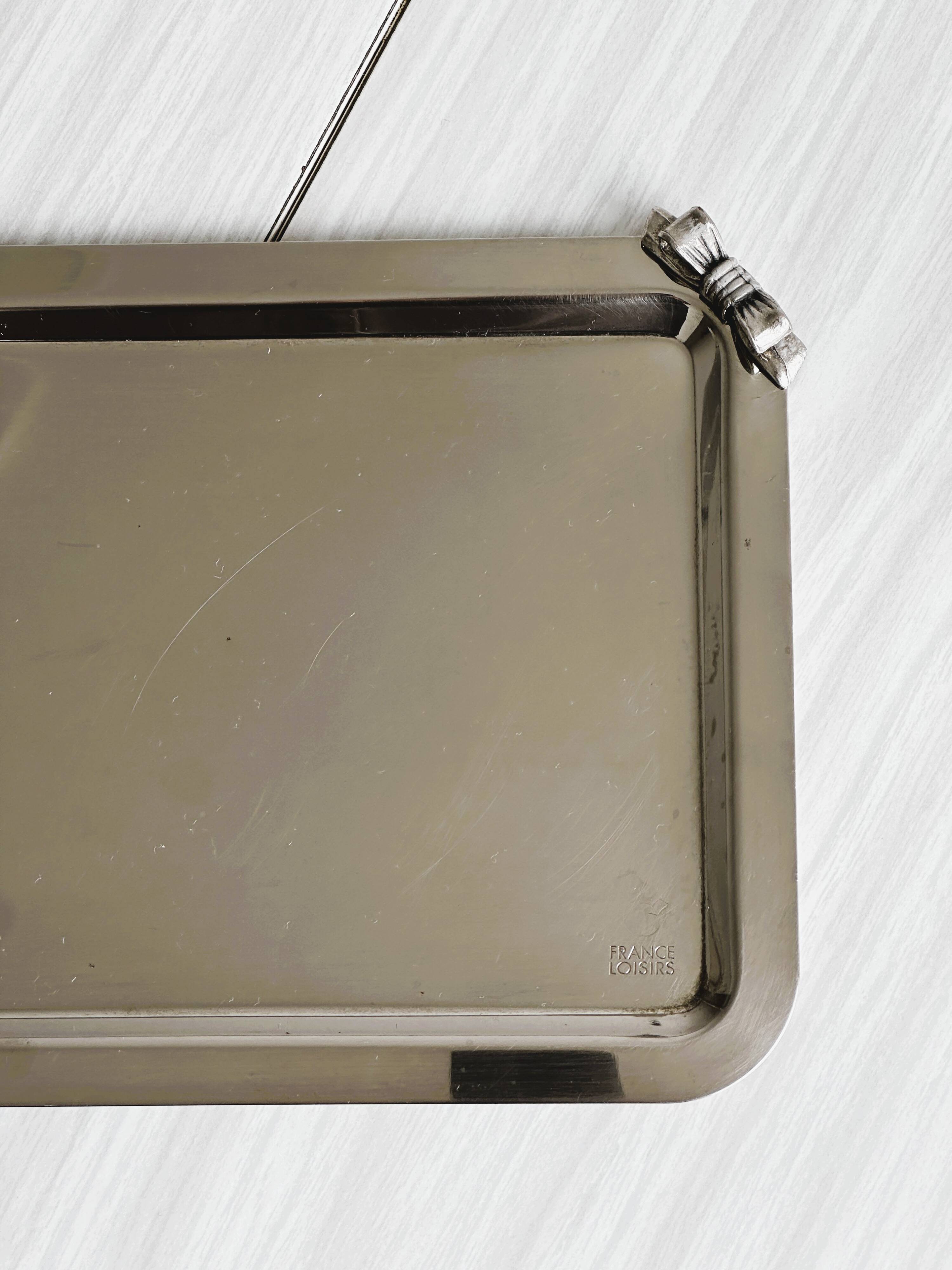 Small vintage metal tray with decorative knot