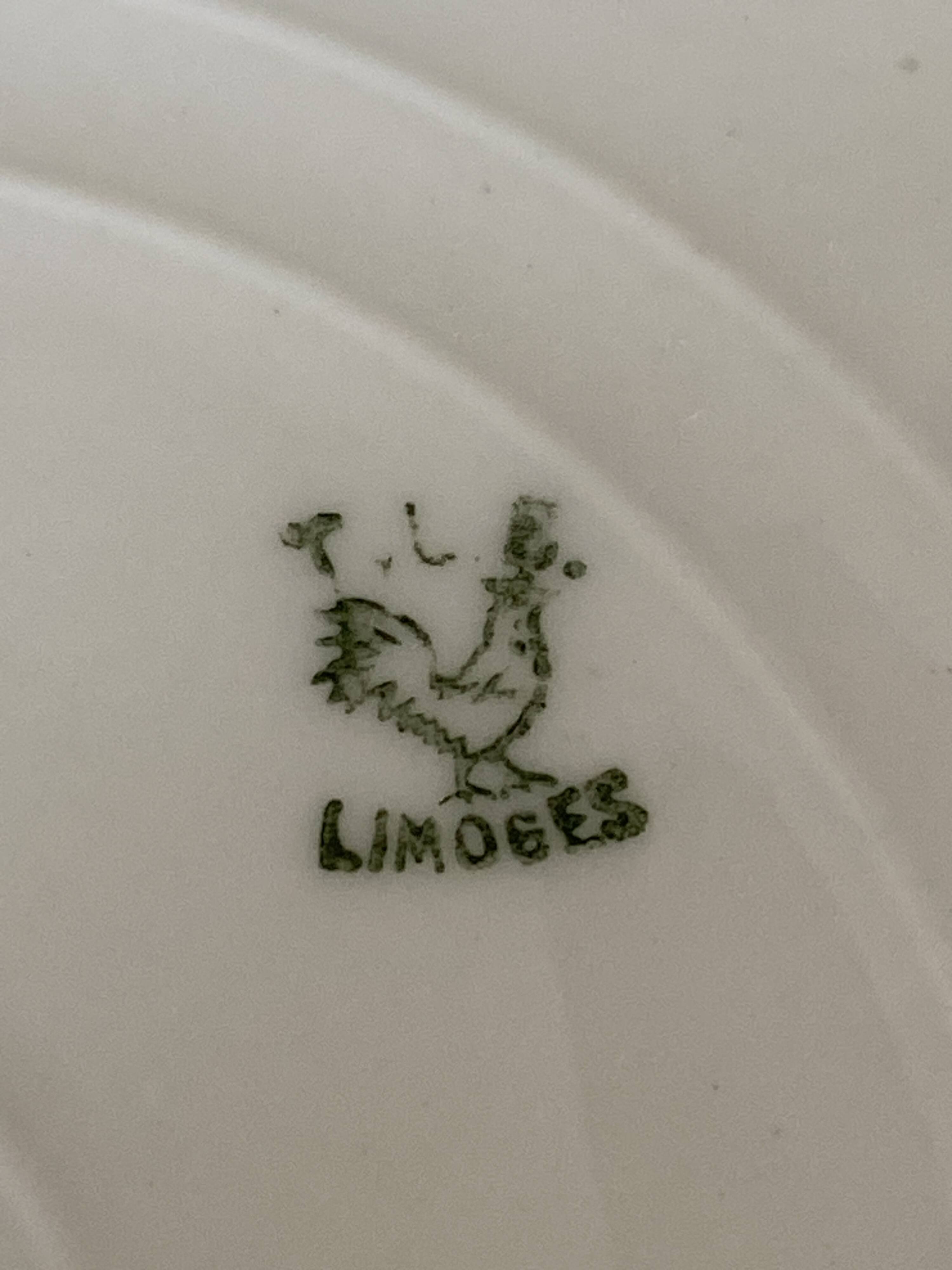 Oval vintage plate in white Limoges porcelain signed T.L.B flowers.