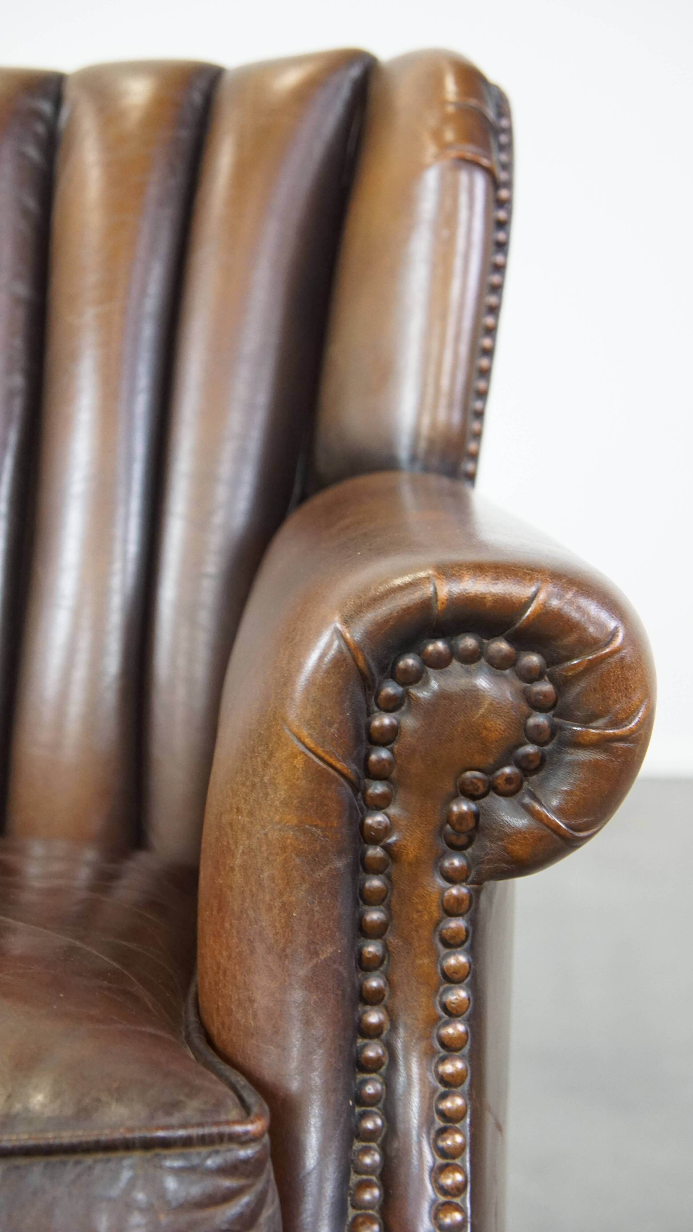 Sheep leather armchair finished with decorative nails