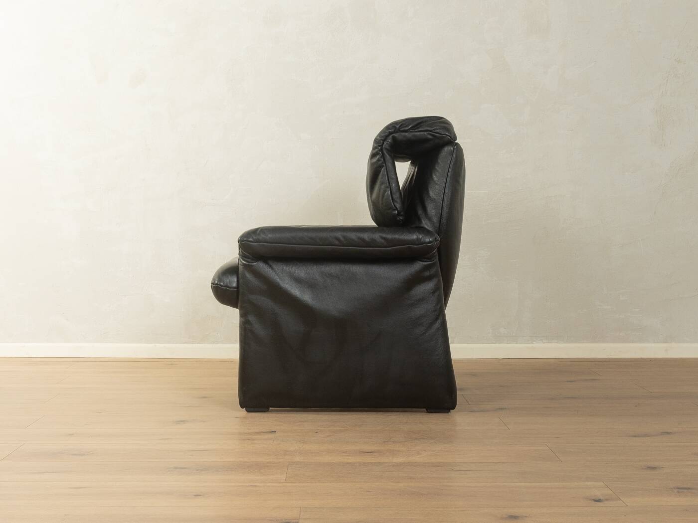 1980s cor armchair and ottoman in black leather