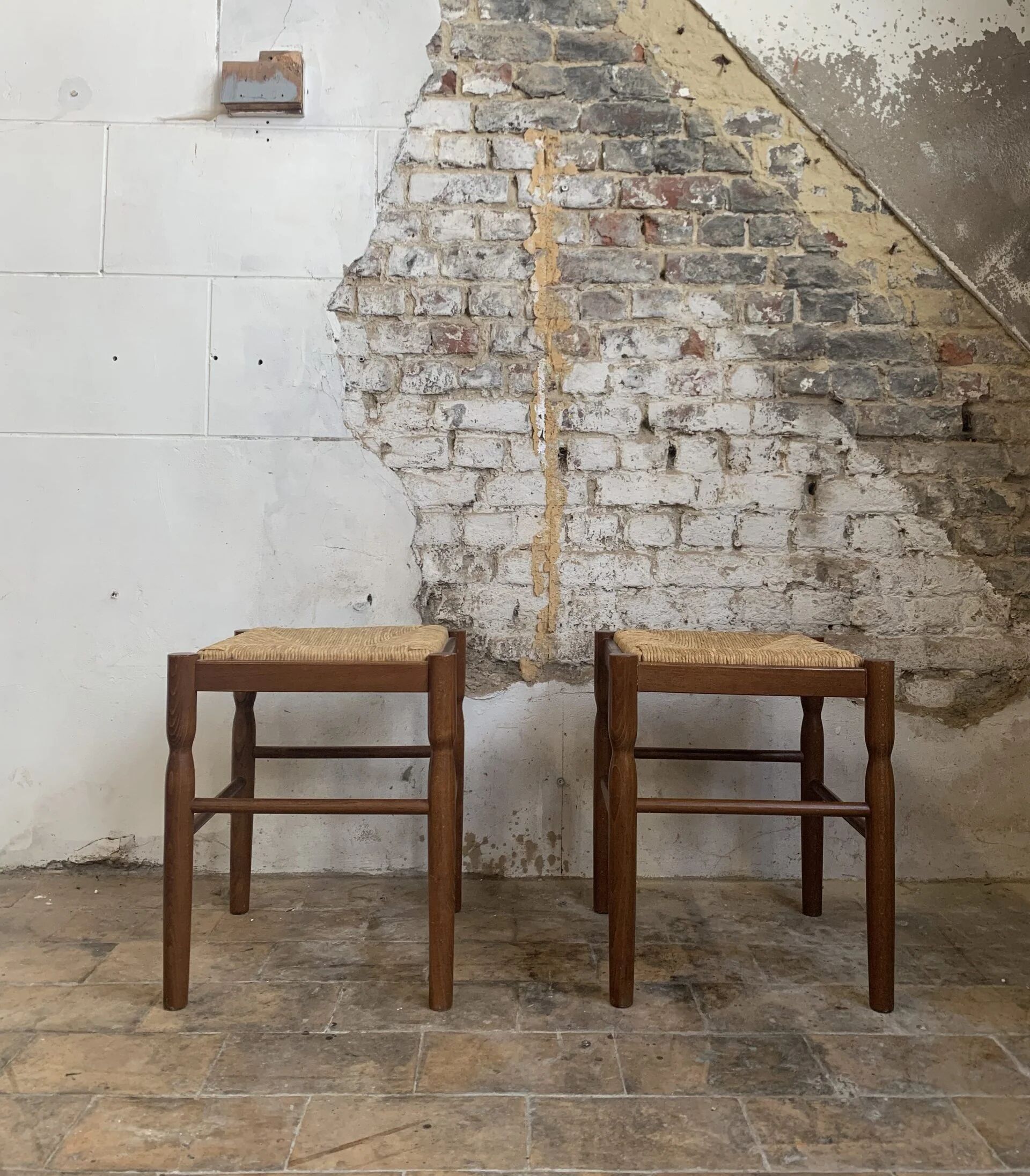 Pair of 20th-century wooden stools with straw seats