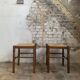 Pair of 20th-century wooden stools with straw seats