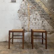 Pair of 20th-century wooden stools with straw seats