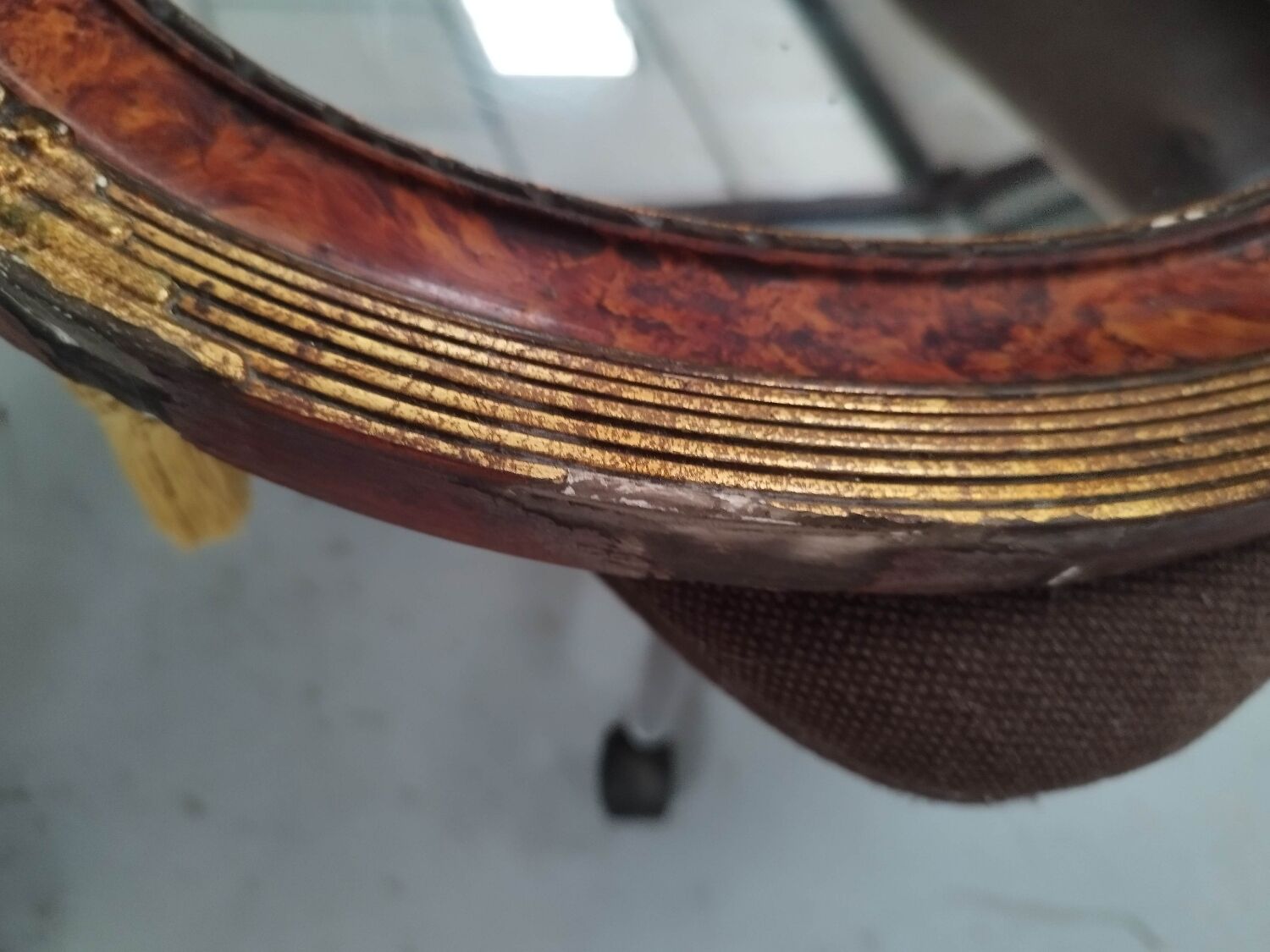 Golden oval art deco mirror