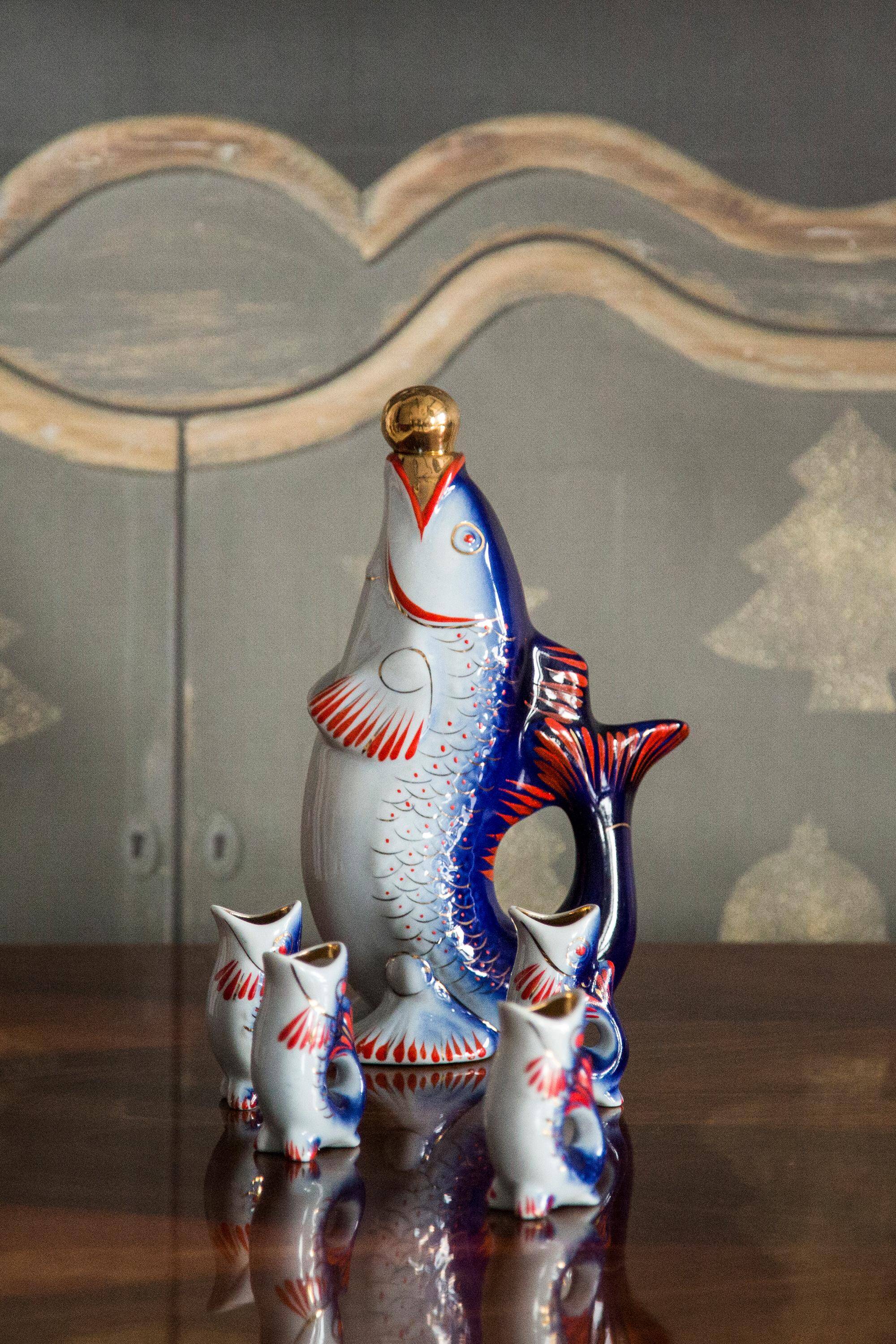 Set of 7 glasses and a glass carafe decorated with blue fish, Mid-Century Modern style, Europe, 1960s.