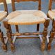 4 or 5 solid wood chairs with light oak straw and high backs