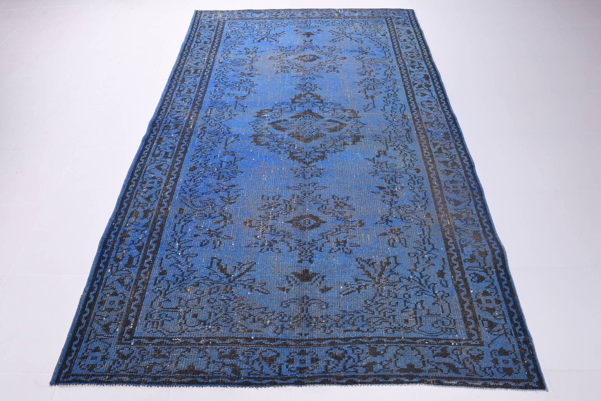 Vintage blue and black Turkish rug with traditional design, 163 × 268 cm