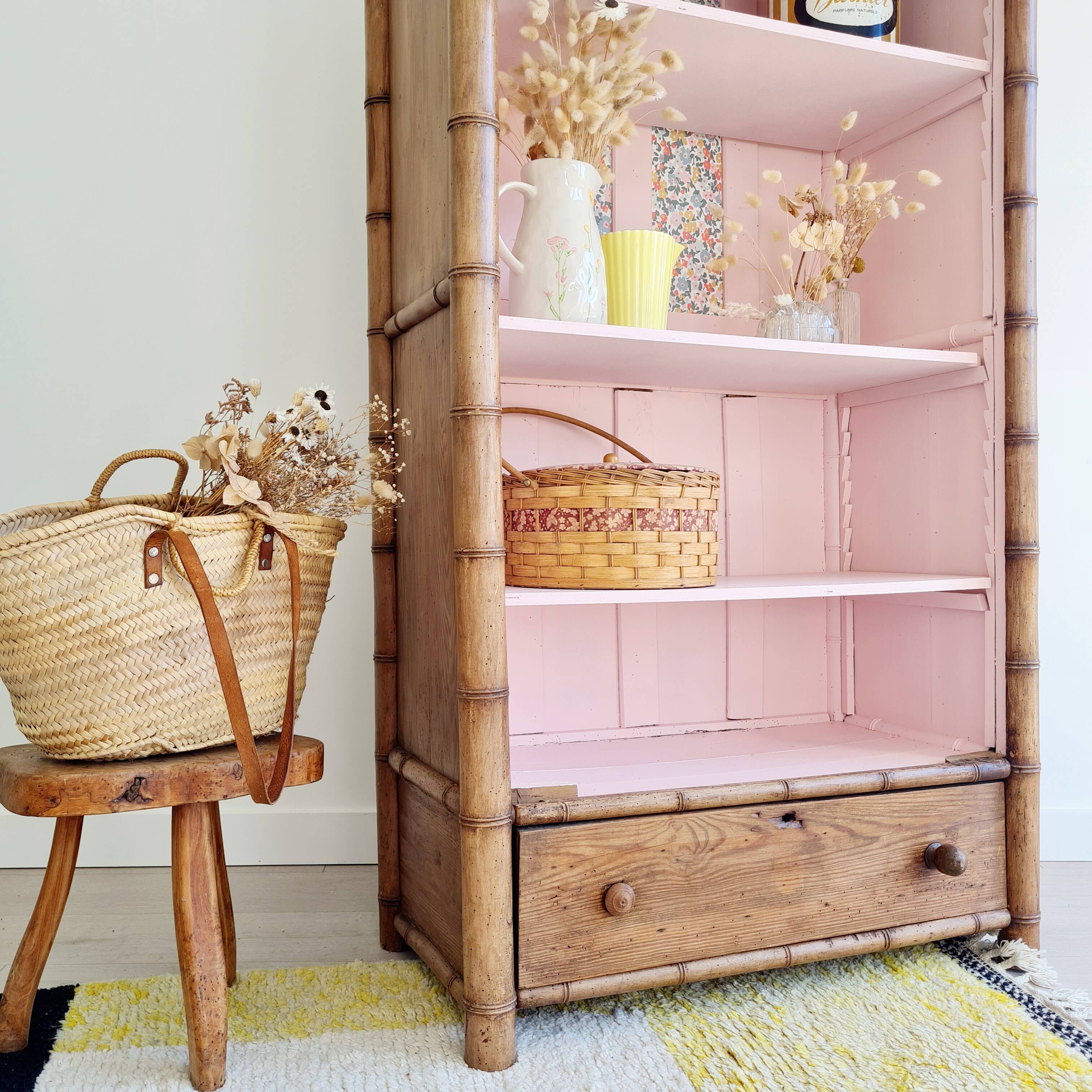 Library, old wooden cabinet imitating bamboo painted in pink