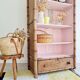 Library, old wooden cabinet imitating bamboo painted in pink