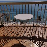 Table and bistro chairs wrought iron terrace