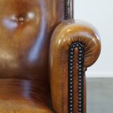 Sheep leather design armchair finished with decorative nails and black piping