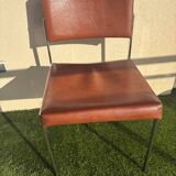 A pair of vintage brown Skaï chairs.