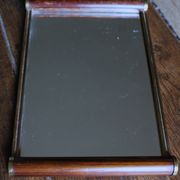 Rectangular mirror tray with wooden handles and gilding.