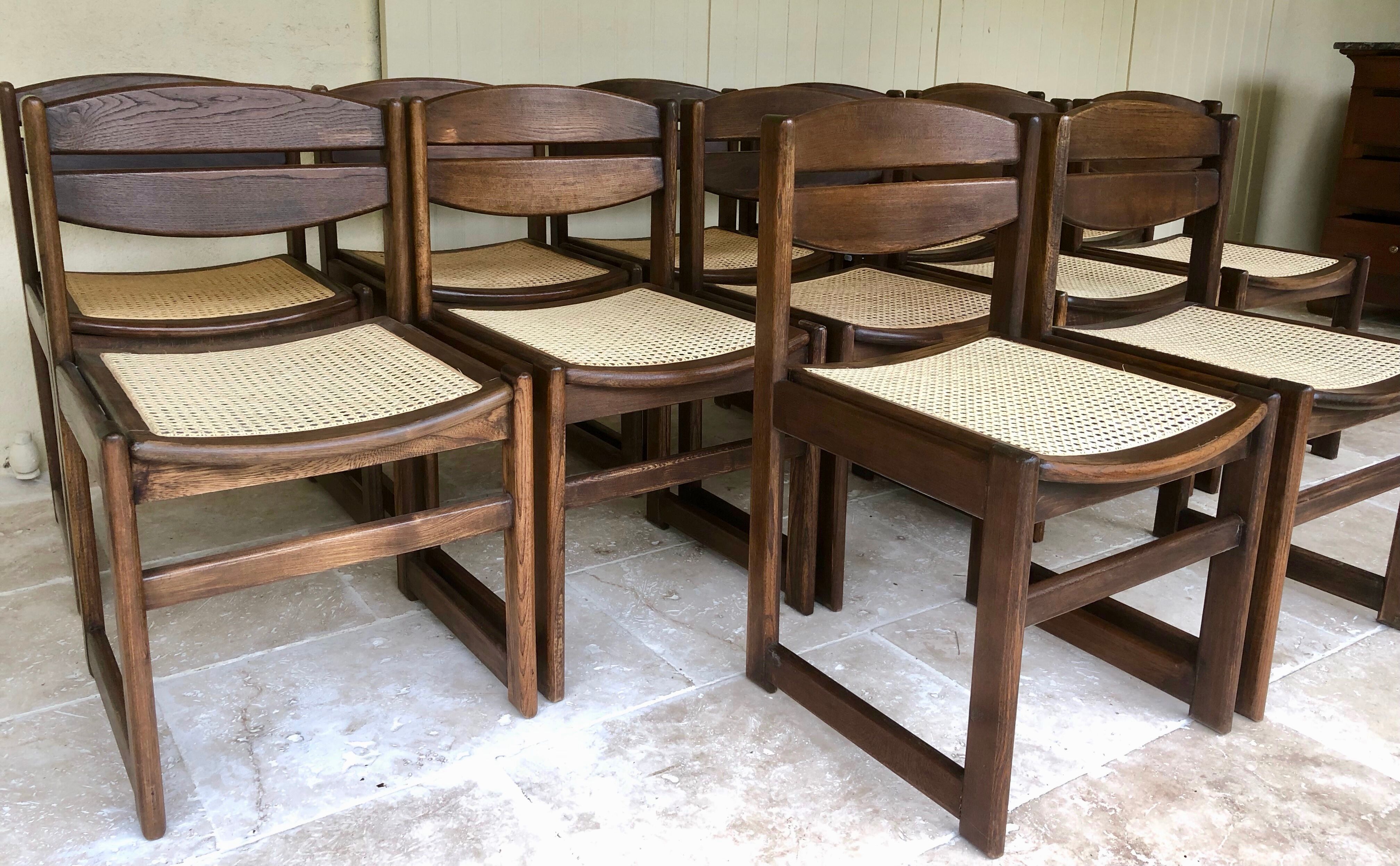 Set of 12 "sledge" dining chairs in walnut and cane.