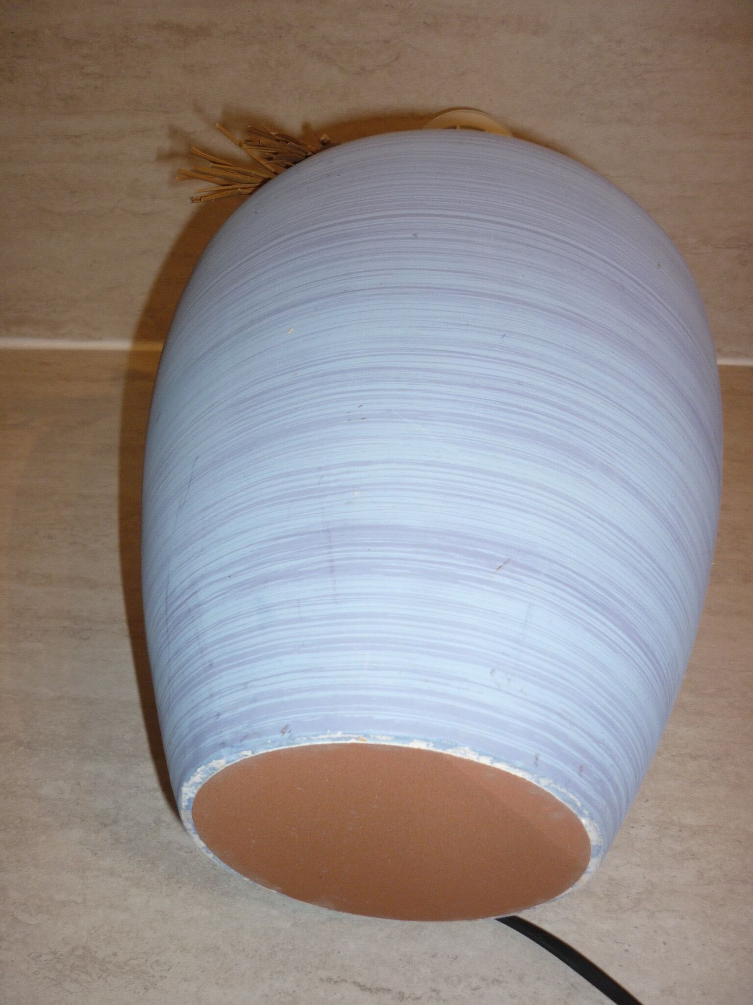 Vintage ceramic lamp foot with ball necklace and raffia.