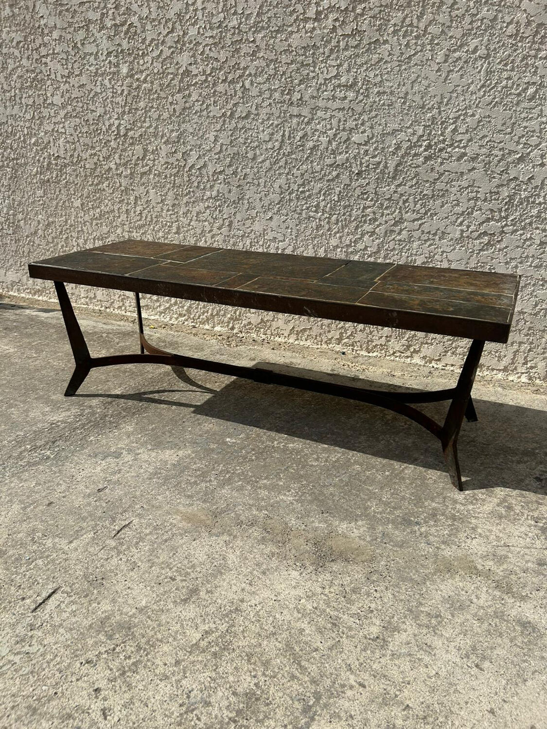 Coffee table with stone top and iron legs