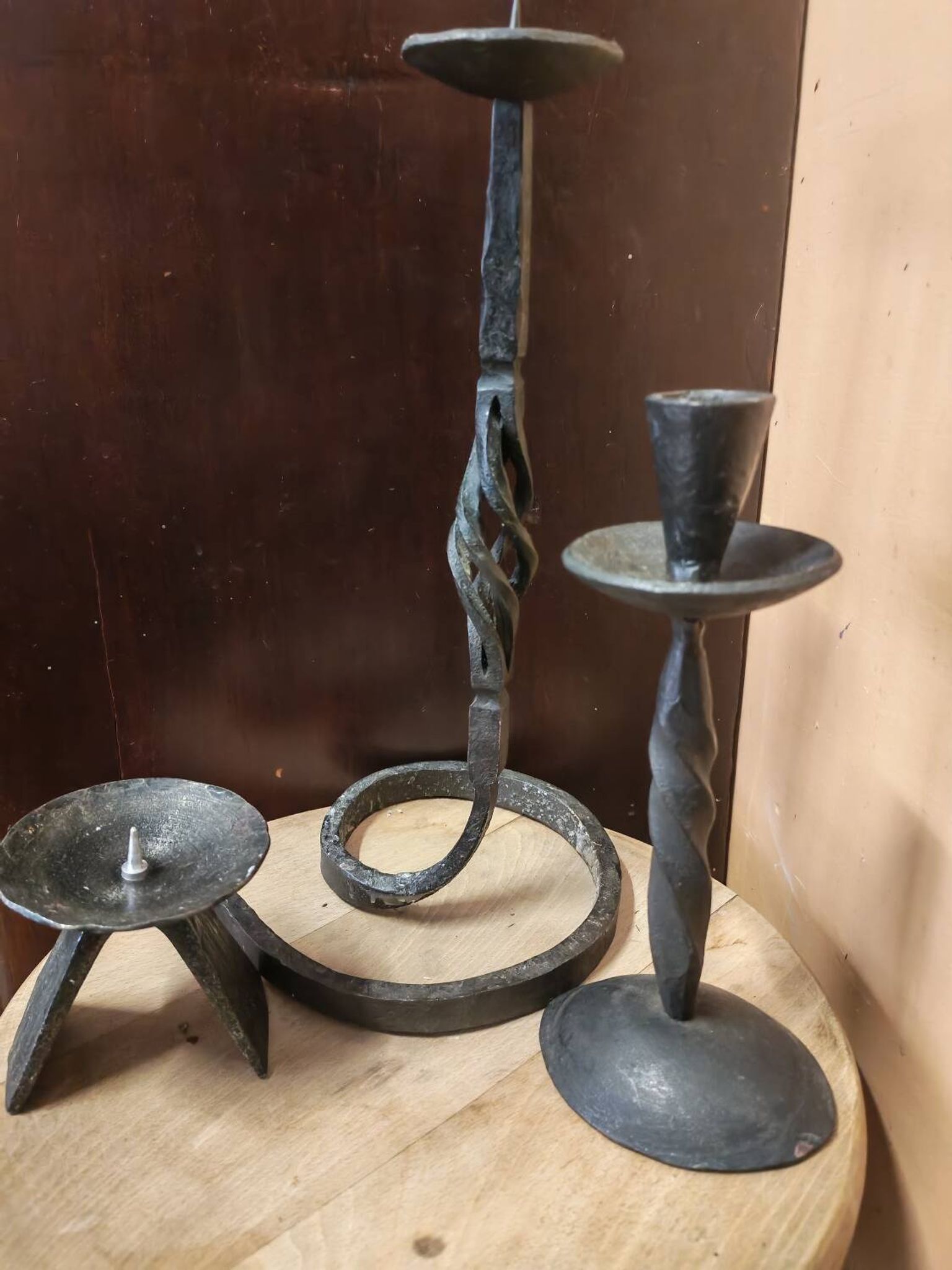 Set of 3 candlesticks and a candle holder in wrought iron.