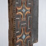 Indonesian construction element in carved wood with cross pattern in red, white geometric frieze
