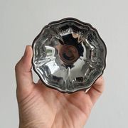 Set of 9 low bowls in shiny stainless steel.