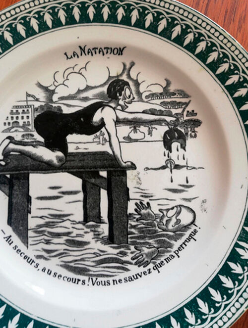 Old vintage dessert plate with drawing and phrase "swimming"
